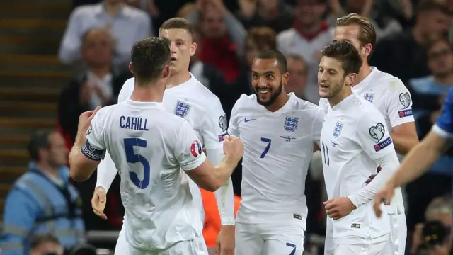 Theo Walcott celebrates with his teammates