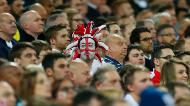 An England fan with face paint in the crowd