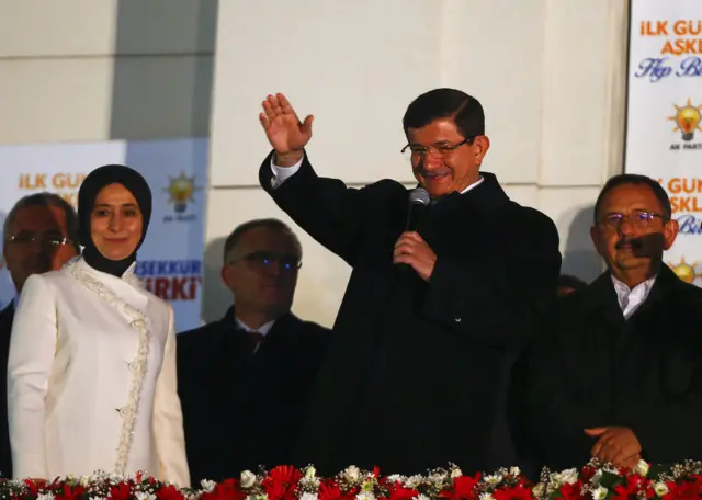 Turkish Prime Minister Ahmet Davutoglu waves to supporters next to his wife Sare from the balcony of the AK Party headquarters in Ankara, Turkey on 2 November 2015