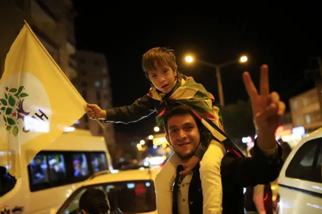 People celebrate preliminary election results of the pro-Kurdish Peoples's Democratic Party (HDP) in Diyarbakir, in Turkey"s predominantly Kurdish southeast, on 1 November 2015