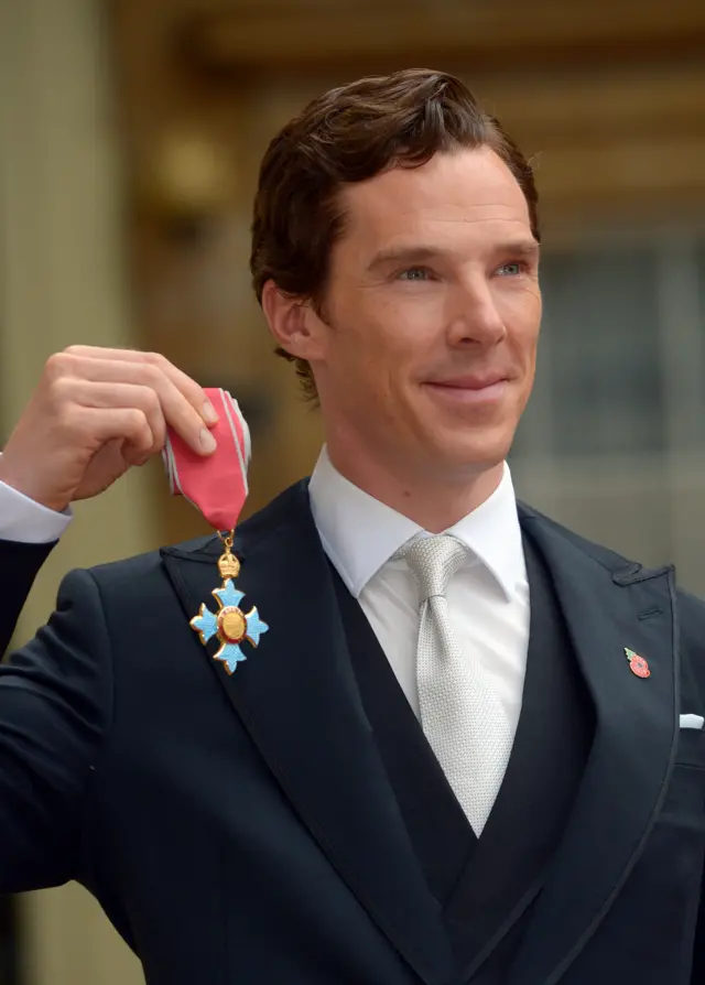 Mr Cumberbatch holds up CBE