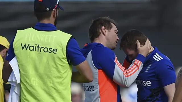 Eoin Morgan receives treatment for a head injury