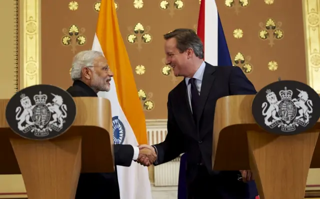 Narendra Modi and David Cameron shake hands after a press conference