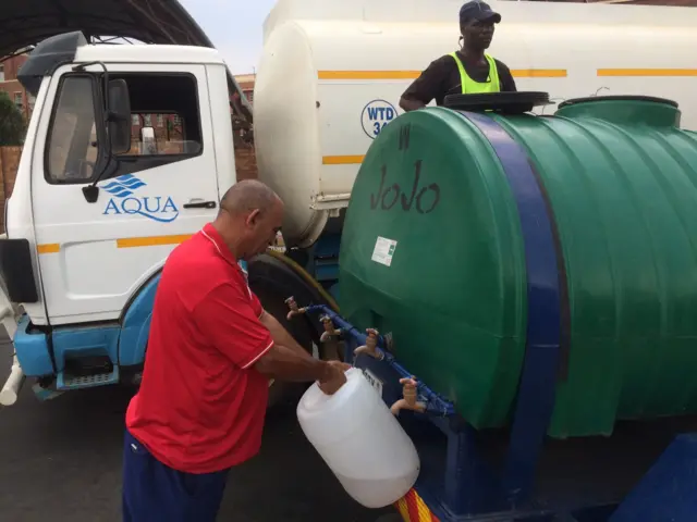 People in the community of Coronationville queuing for water