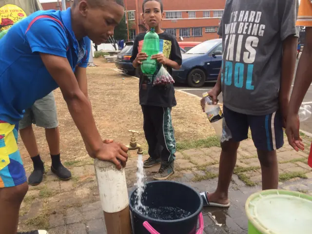 People in the community of Coronationville queuing for water