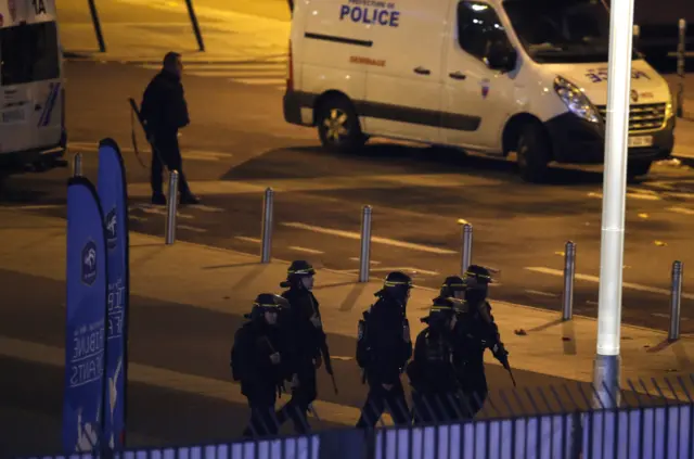 Police officers take position outside the Stade de France stadium after the international friendly soccer France against Germany