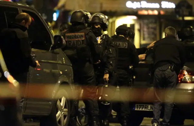 Police officers man a position close to the Bataclan theatre