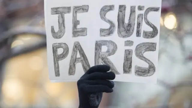 A man holds up a sign which reads: "Je Suis Paris" (I Am Paris) in Montreal, Canada