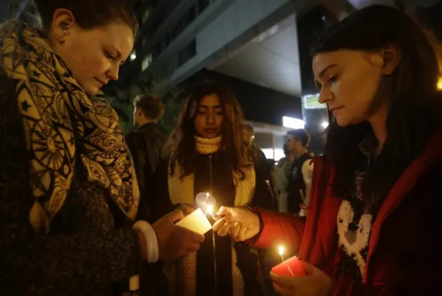 People light candles at the French ambassador's residence in Seoul