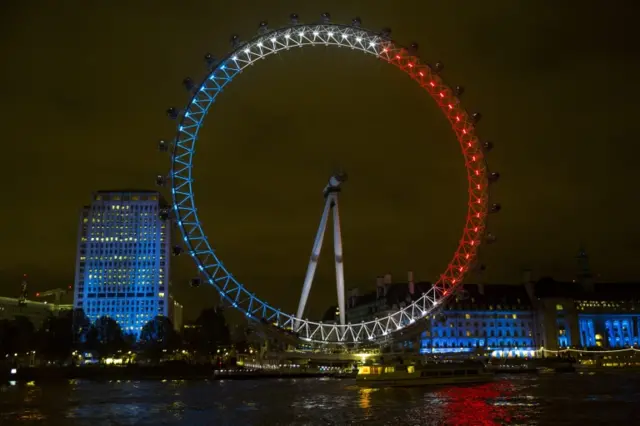 The London Eye is lit up in the colours of the French flag