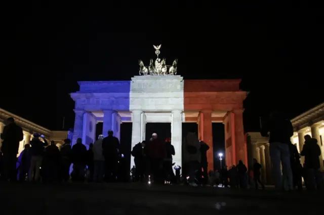 The Brandenburg Gate in Berlin is lit up in the colours of the French flag