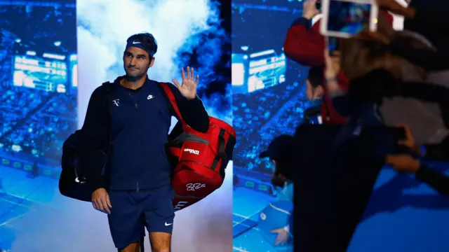 Roger Federer walks on court