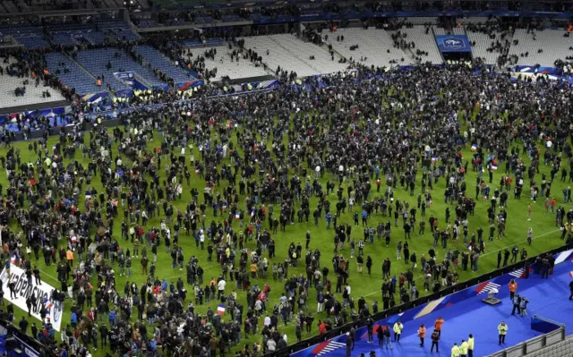 Fans ran on to the pitch at the Stade de France after hearing reports of the attack