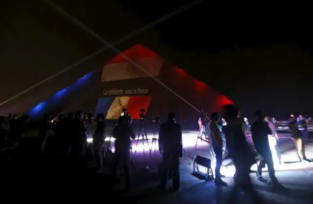 Blue white and red light project on to one of the Giza pyramids in Egypt.