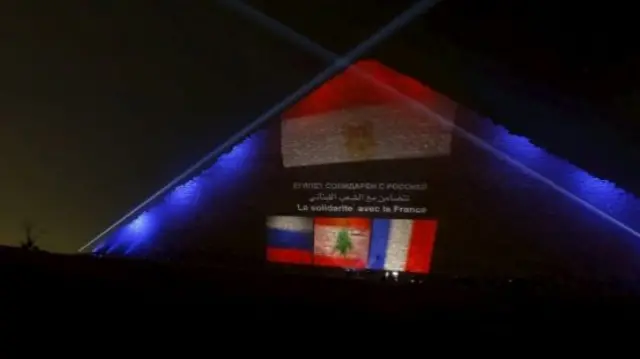 The French, Russian and Lebanese flags are projected onto the Great Pyramid in Egypt