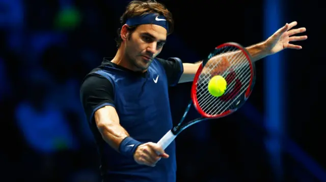 Roger Federer hits a backhand