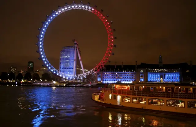 The London Eye lit in the tricolour colours of the French flag