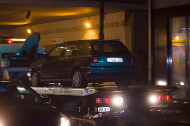 A car is towed during a police raid in Brussels" Molenbeek district on November 14, 2015,