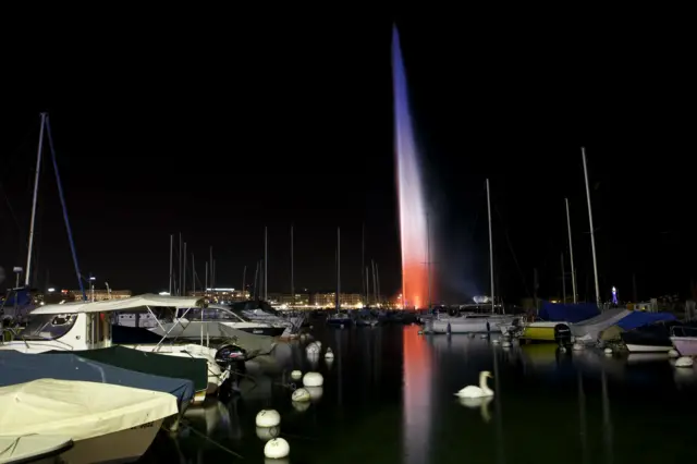 Geneva's Jet d'Eau water fountain is illuminated in the French colors