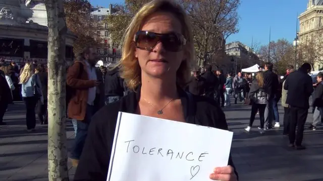 Lady holding up a sign saying 'tolerance'