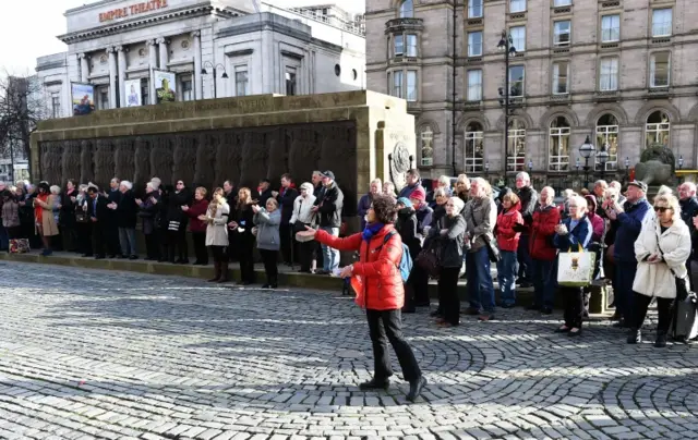 Woman throws confetti in Liverpool