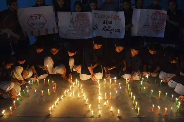 Schoolgirls light candles during a vigil at a school in Amritsar, India