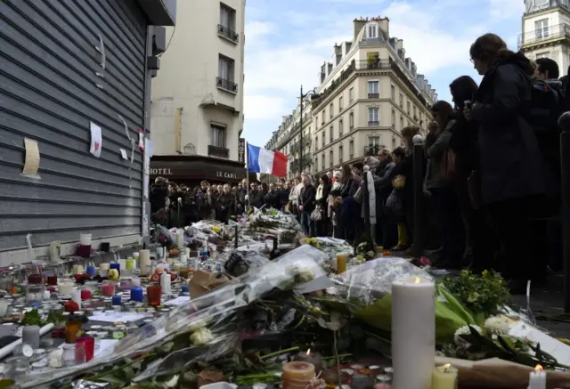 Crowds gathered in the streets around Le petit Cambodge restaurant - the location of one of the attacks