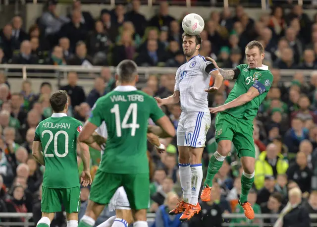 Glenn Whelan challenges a Bosnia attacker