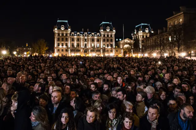 Large numbers of people gathered outside Notre Dame cathedral on Sunday night for a memorial service to the victims