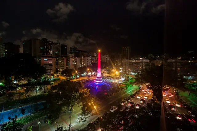 A monument in Plaza Francia (France's Square) in Caracas, Venezuela, is lit up in the colours of the French flag.