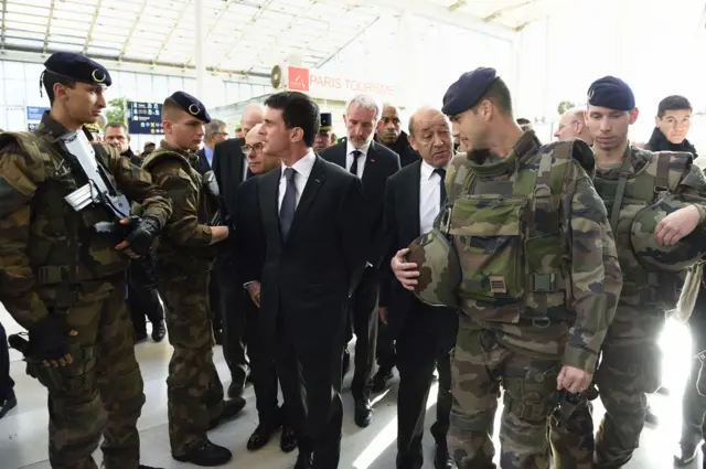 French Prime Minister Manuel Valls (centre) with (right) French Defence Minister Jean-Yves Le Drian, French national rail company SNCF Chairman Guillaume Pepy and French Interior Minister Bernard Cazeneuve at the Gare du Nord railway station in Paris on Sunday, to speak with SNCF staff about security measures