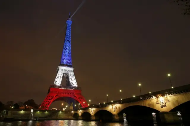 The Eiffel Tower is lit with the blue, white and red colours of the French flag in Paris, France, November 16, 2015,