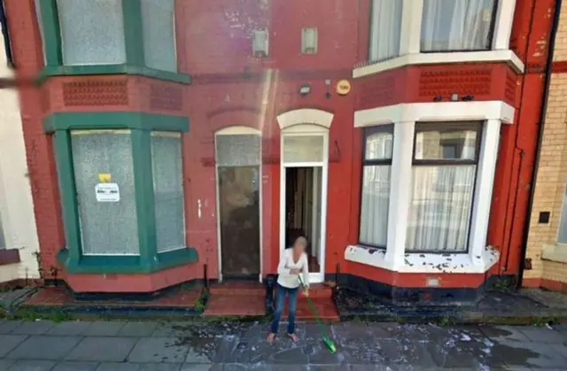 Lynda Hunter cleaning her step in Liverpool