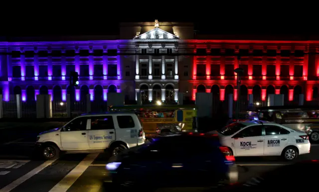 Motorists drive past De La Salle university in the Philippines which is lit with blue, white and red, colours of France"s flag, as a tribute for the victims of Paris attack