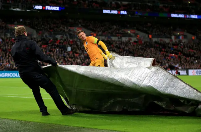 Jack Butland takes a banner from the pitch