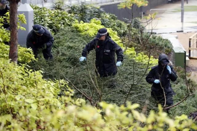 Police officers search the area outside Wembley Stadium