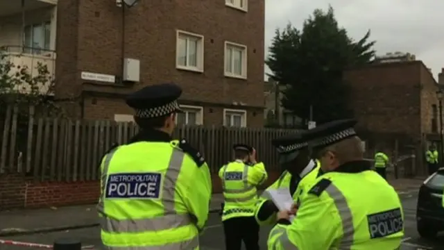 Policemen at the scene of the stabbing