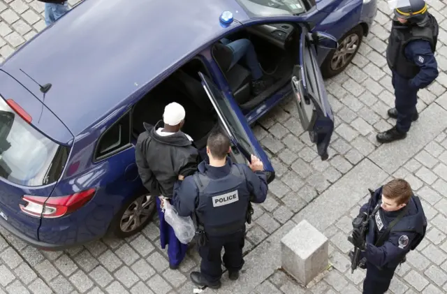 Police officers arrest a man in Saint-Denis,