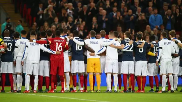 Both teams stand together for a moment of applause