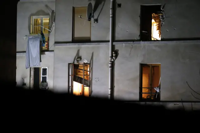 Bullet holes and smashed windows are pictured on the back side of the house after an intervention of security forces against a group of extremists in Saint-Denis, near Paris, on Wednesday