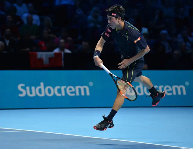 Kei Nishikori serves