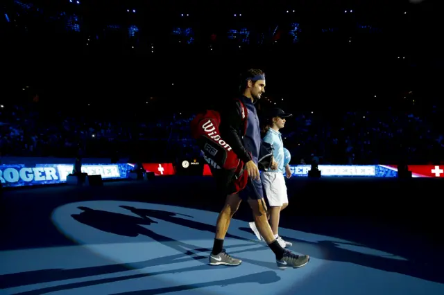 Roger Federer walks out ahead of his match