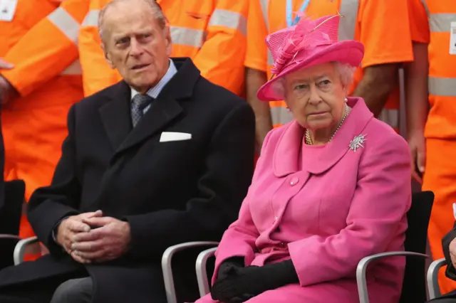 Prince Philip, Duke of Edinburgh amd Queen Elizabeth II listen to a choir during the official opening of the refurbished Birmingham New Street Station on November 19, 2015