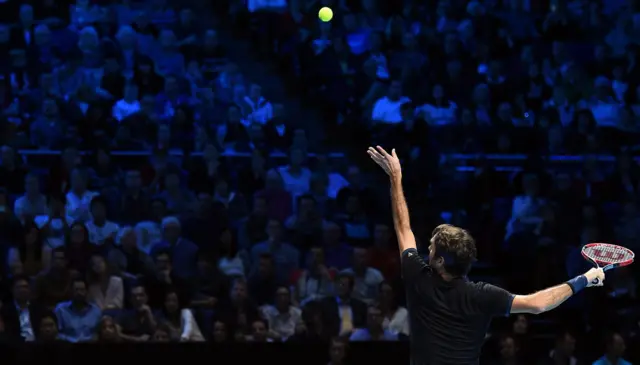 Roger Federer serves