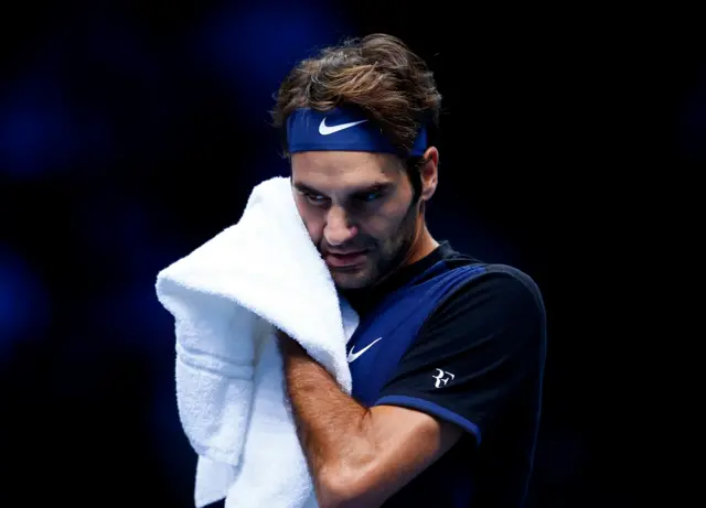 Roger Federer towels himself during the match