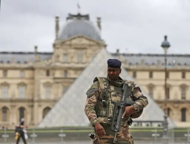 A soldier patrols in the courtyard of the Louvre Museum in Paris