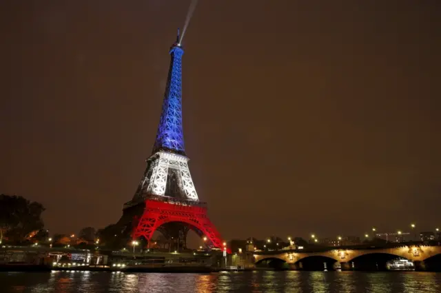 Eiffel tower lit in blue, white and red