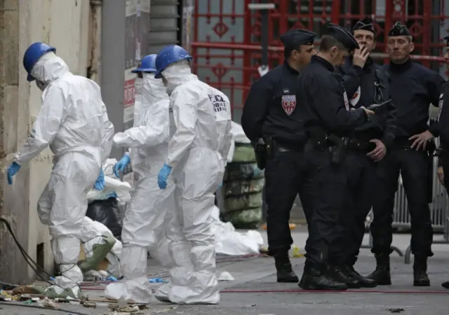 Forensics teams investigate the scene in Saint Denis