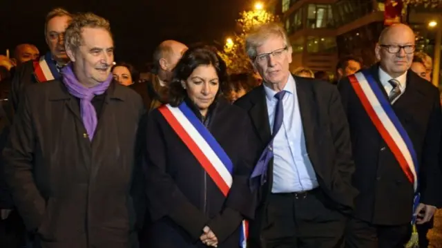 Paris Mayor Anne Hidalgo (centre) and Saint Denis Mayor Didier Paillard (right) attend a homage ceremony near the Stade de France