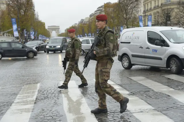 French soldiers patrol on the Champs-Elysees avenue, on November 19, 2015, as part of the security measures set following the November 13 attacks